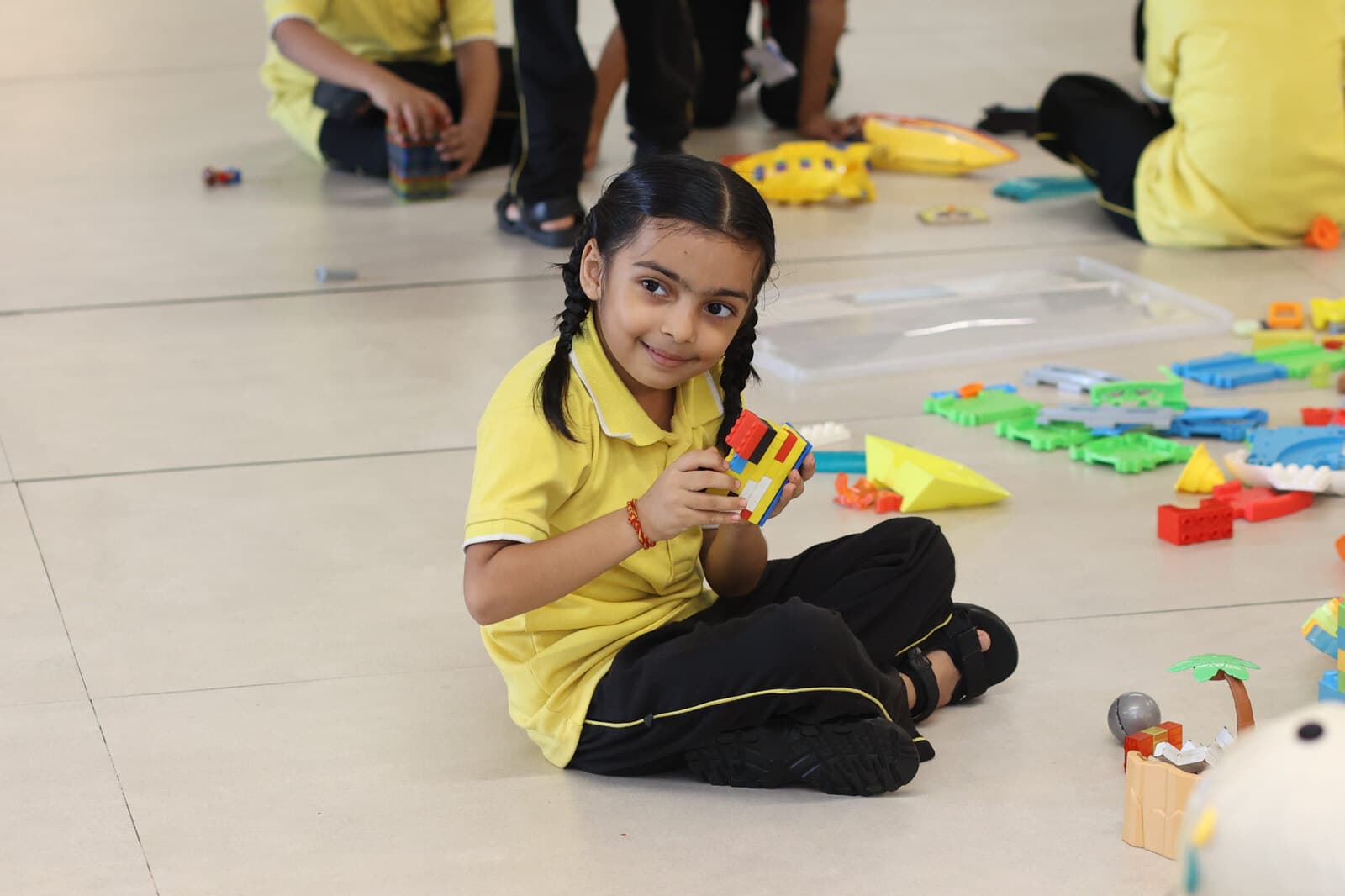 A Shikha Academy student creating with construction materials